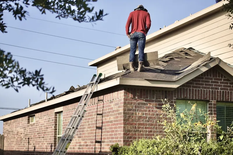 Professional roofer working on a residential roof in Eunice
